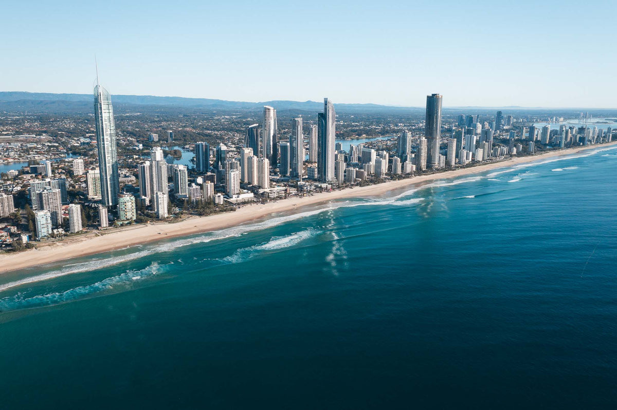 Aerial photograph of the Surfers Paradise skyline and beach on the Gold Coast, Queensland, with deep blue ocean and the Broadwater in the distance