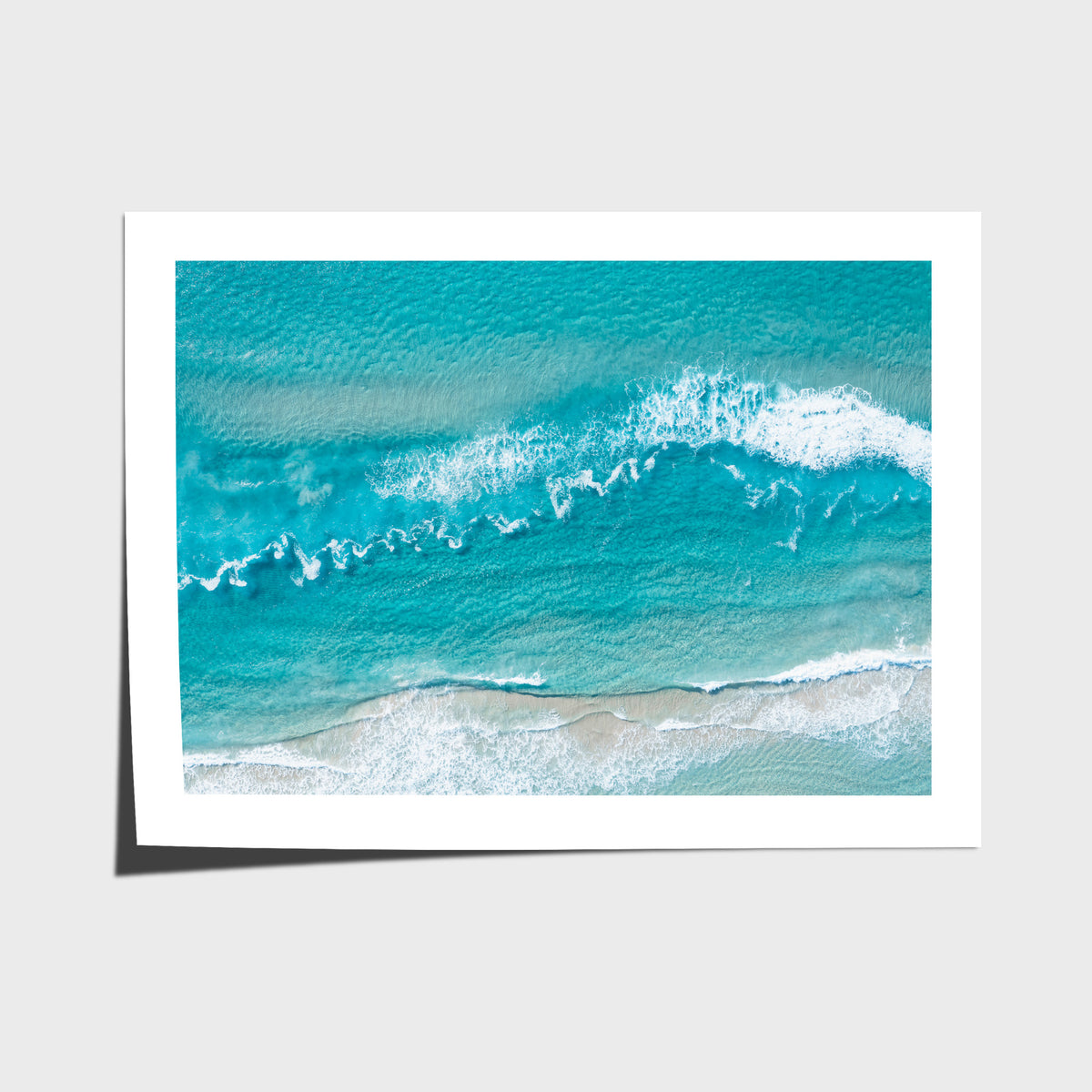 Top-down aerial view of turquoise water and white waves breaking over a sandbank at Surfers Paradise beach, Gold Coast